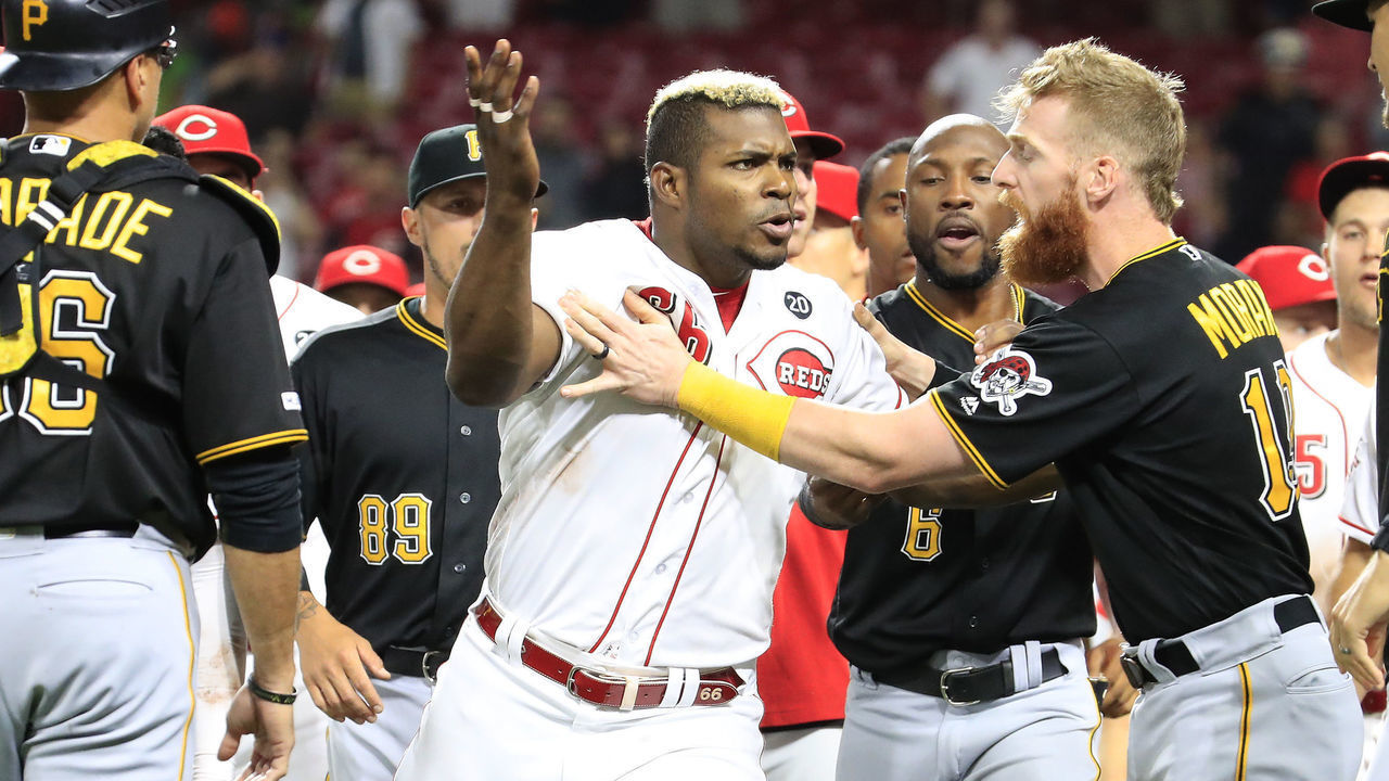 CINCINNATI, OHIO - JULY 30: Yasiel Puig #66 of the Cincinnati Reds is restrained during a bench clearing altercation in the 9th inning of the game against the Pittsburgh Pirates at Great American Ball Park on July 30, 2019 in Cincinnati, Ohio.