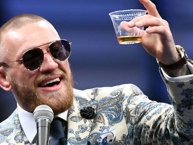 LAS VEGAS, NV - AUGUST 26: Conor McGregor holds up a cup of his Notorious-branded Irish whiskey as he speaks during a news conference following his 10th-round TKO loss to Floyd Mayweather Jr. in their super welterweight boxing match at T-Mobile Arena on August 26, 2017 in Las Vegas, Nevada.