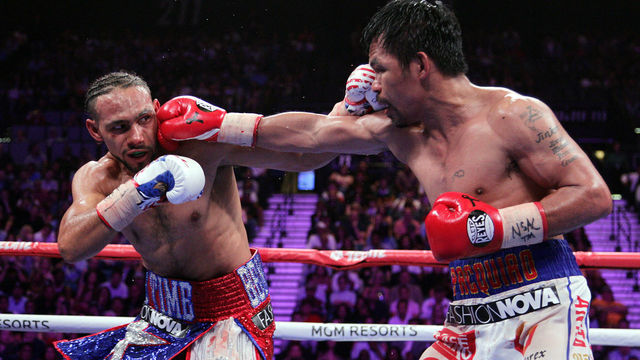 Filipino boxer Manny Pacquiao (R) connects with a right to the face of US boxer Keith Thurman during their WBA super world welterweight title fight at the MGM Grand Garden Arena on July 20, 2019 in Las Vegas, Nevada. - Pacquiao won a 12 round split decision.