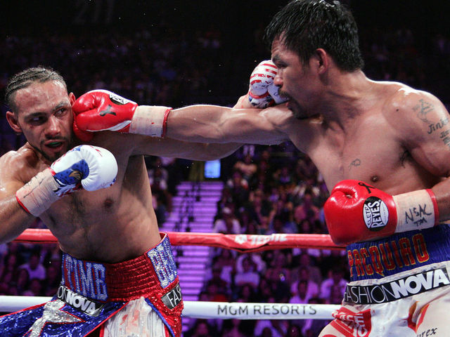 Filipino boxer Manny Pacquiao (R) connects with a right to the face of US boxer Keith Thurman during their WBA super world welterweight title fight at the MGM Grand Garden Arena on July 20, 2019 in Las Vegas, Nevada. - Pacquiao won a 12 round split decision.