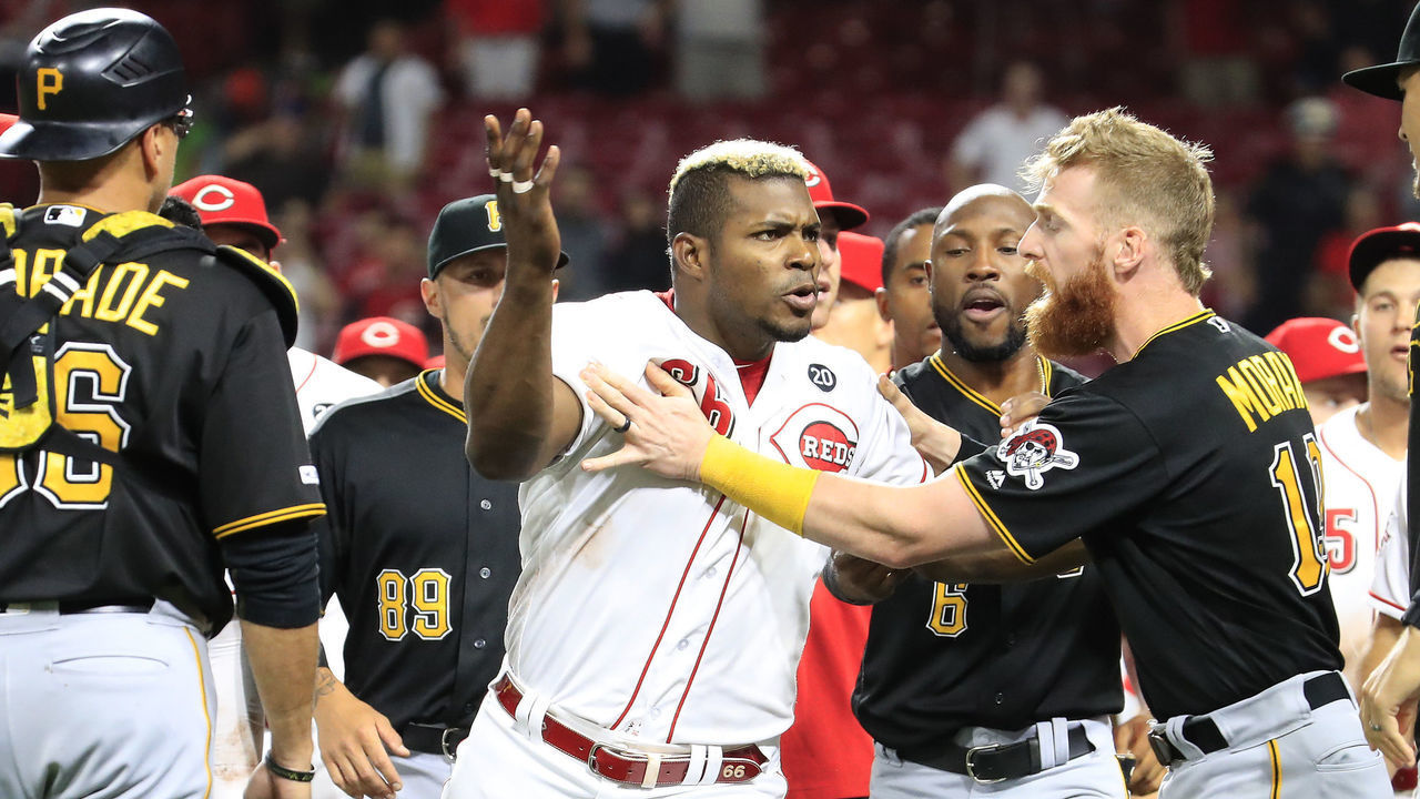 CINCINNATI, OHIO - JULY 30: Yasiel Puig #66 of the Cincinnati Reds is restrained during a bench clearing altercation in the 9th inning of the game against the Pittsburgh Pirates at Great American Ball Park on July 30, 2019 in Cincinnati, Ohio.