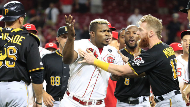 CINCINNATI, OHIO - JULY 30: Yasiel Puig #66 of the Cincinnati Reds is restrained during a bench clearing altercation in the 9th inning of the game against the Pittsburgh Pirates at Great American Ball Park on July 30, 2019 in Cincinnati, Ohio.