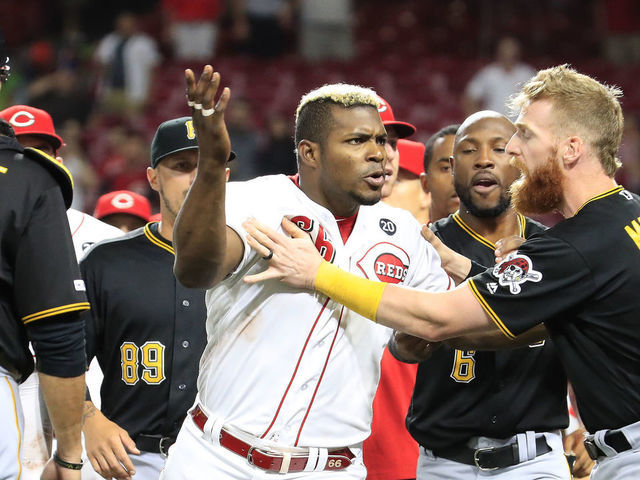 CINCINNATI, OHIO - JULY 30: Yasiel Puig #66 of the Cincinnati Reds is restrained during a bench clearing altercation in the 9th inning of the game against the Pittsburgh Pirates at Great American Ball Park on July 30, 2019 in Cincinnati, Ohio.