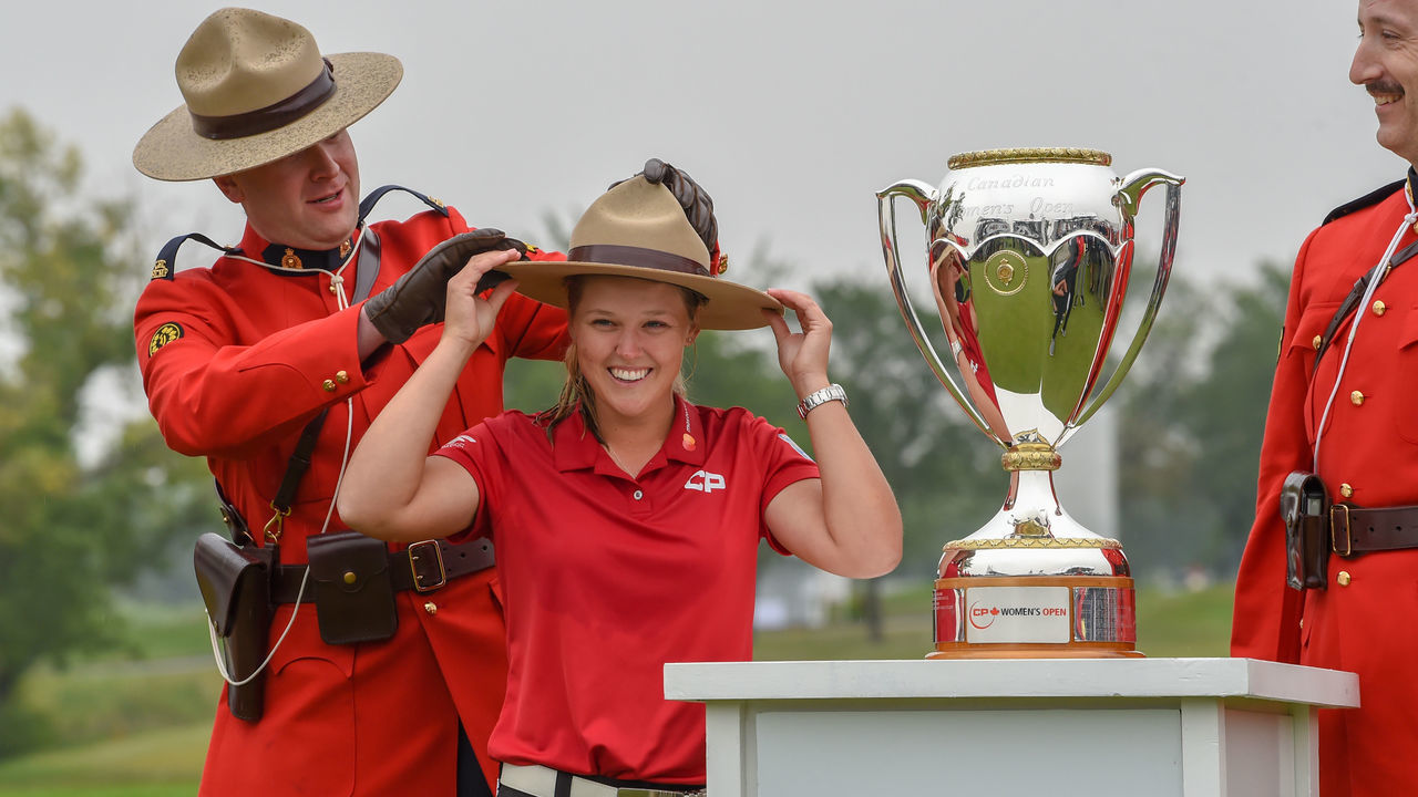 REGINA, SK - AUGUST 26: Brooke M. Henderson (CAN) dons a Mountie's hat and shares a big laugh with the gallery after winning the 2018 CP Women's Open Round 4 at Wascana Country Club on August 26, 2018 in Regina, SK, Canada.