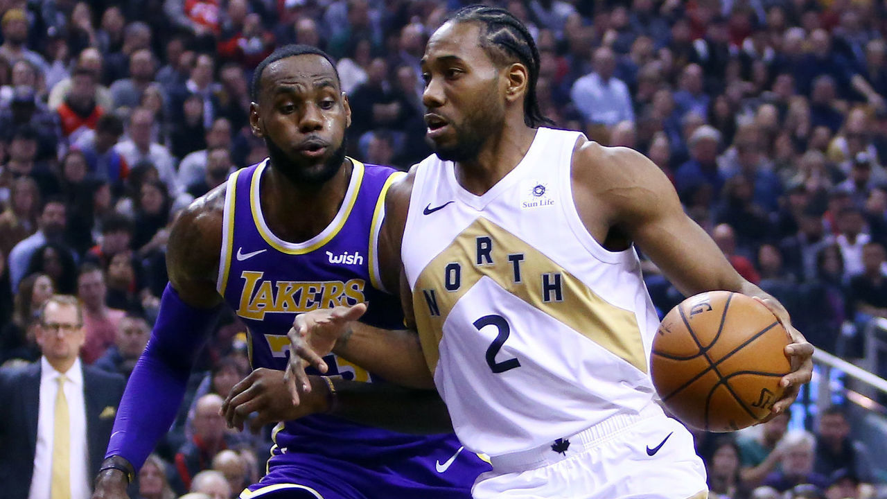 TORONTO, ON - MARCH 14: Kawhi Leonard #2 of the Toronto Raptors dribbles the ball as LeBron James #23 of the Los Angeles Lakers defends during the first half of an NBA game at Scotiabank Arena on March 14, 2019 in Toronto, Canada.