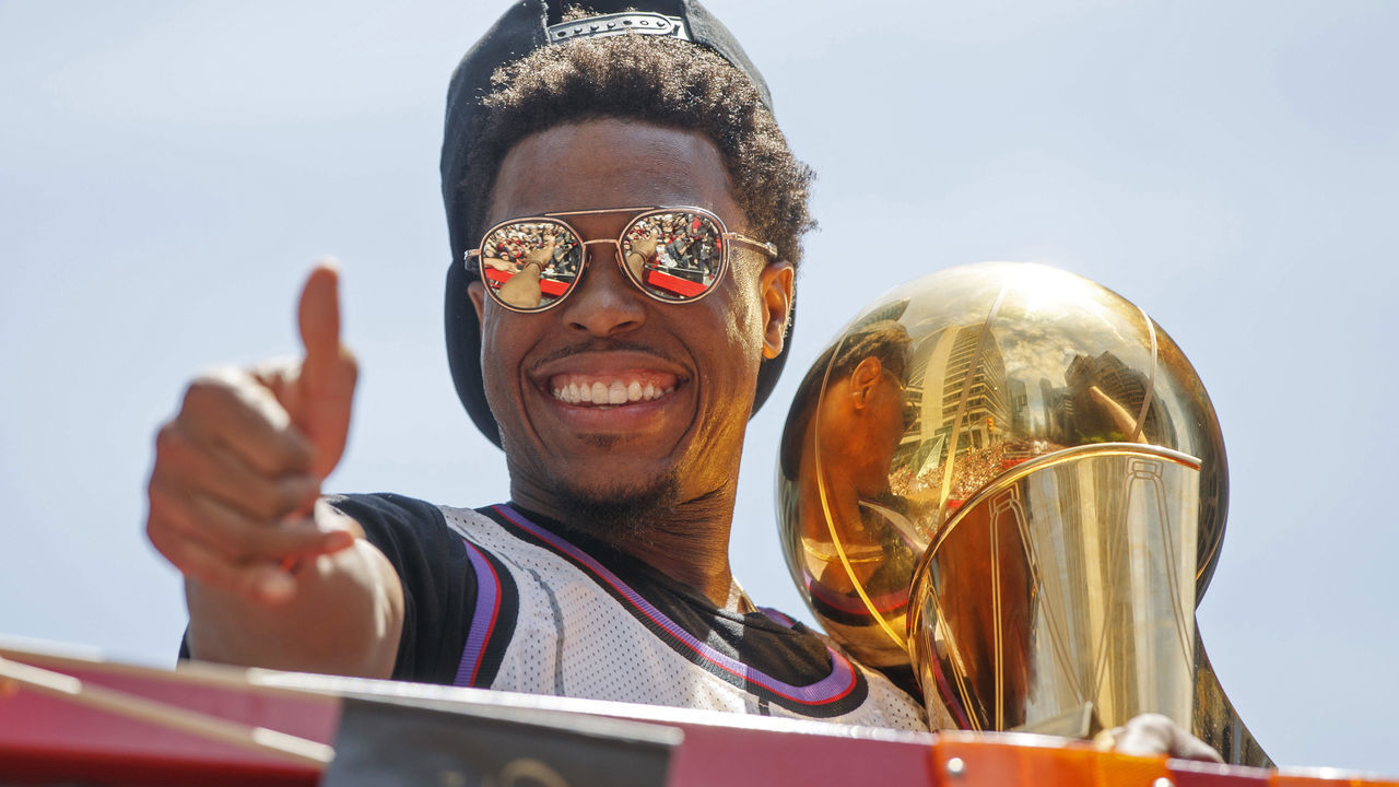 TORONTO, ON - JUNE 17: Kyle Lowry #7 of the Toronto Raptors holds the Larry O'Brien Championship Trophy on the team bus during the Toronto Raptors Championship Victory Parade on June 17, 2019 in Toronto, Ontario. NOTE TO USER: User expressly acknowledges and agrees that, by downloading and/or using this photograph, user is consenting to the terms and conditions of Getty Images License Agreement. Mandatory Copyright Notice: Copyright 2019 NBAE