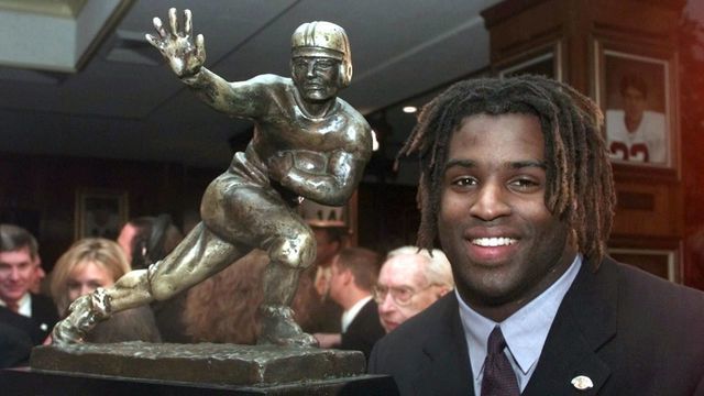 NEW YORK, NY - DECEMBER 12: Texas tailback Ricky Williams, winner of the 1998 Heisman trophy, poses with US college football's highest honor 12 December at the Downtown Athletic Club in New York. Williams ran for 2,124 yards and broke Tony Dorsett's 22-year-old record career rushing record as he led the Longhorns to an 8-3 record and a trip to the Cotton Bowl on 01 January 1999.