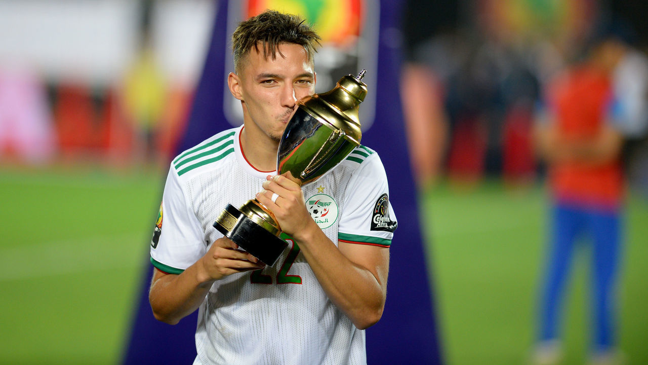 TOPSHOT - Algeria's midfielder Ismail Bennacer (2nd-L) celebrates the trophy of best young player after winning the 2019 Africa Cup of Nations (CAN) Final football match between Senegal and Algeria at the Cairo International Stadium in Cairo on July 19, 2019.