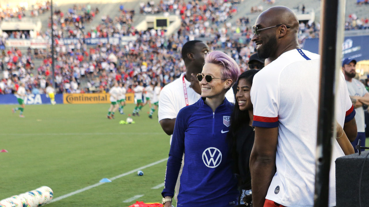 PASADENA, CALIFORNIA - AUGUST 03: Megan Rapinoe #15 of United States takes a photo with Kobe Bryant before the first half against Republic of Ireland at the first game of the USWNT Victory Tour at Rose Bowl on August 03, 2019 in Pasadena, California.
