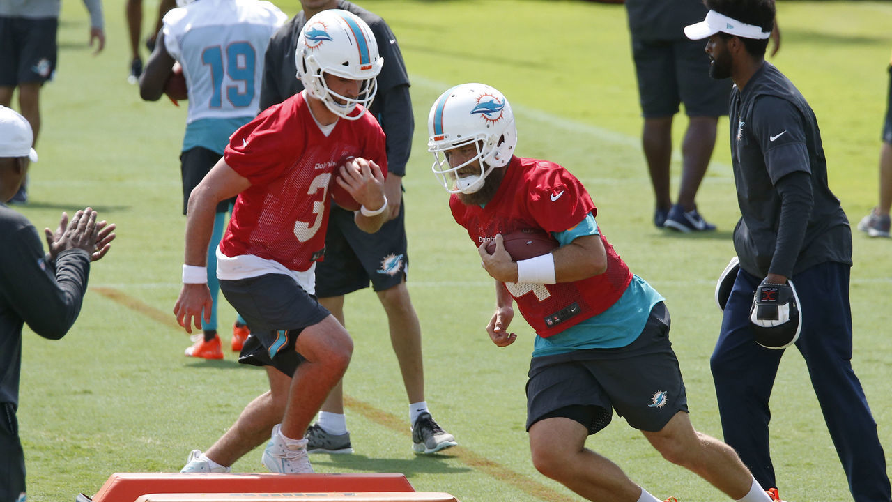 DAVIE, FL - MAY 14: Josh Rosen #3 and Ryan Fitzpatrick #14 of the Miami Dolphins run a drill during the Miami Dolphins OTA"u2019s on May 14, 2019 at the Miami Dolphins training facility in Davie, Florida.