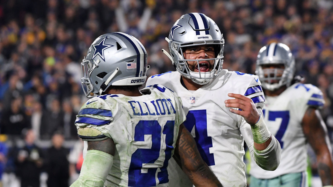 LOS ANGELES, CA - JANUARY 12: Dak Prescott #4 and Ezekiel Elliott #21 of the Dallas Cowboys react after a Prescott touchdown late in the fourth quarter against the Los Angeles Rams in the NFC Divisional Playoff game at Los Angeles Memorial Coliseum on January 12, 2019 in Los Angeles, California.