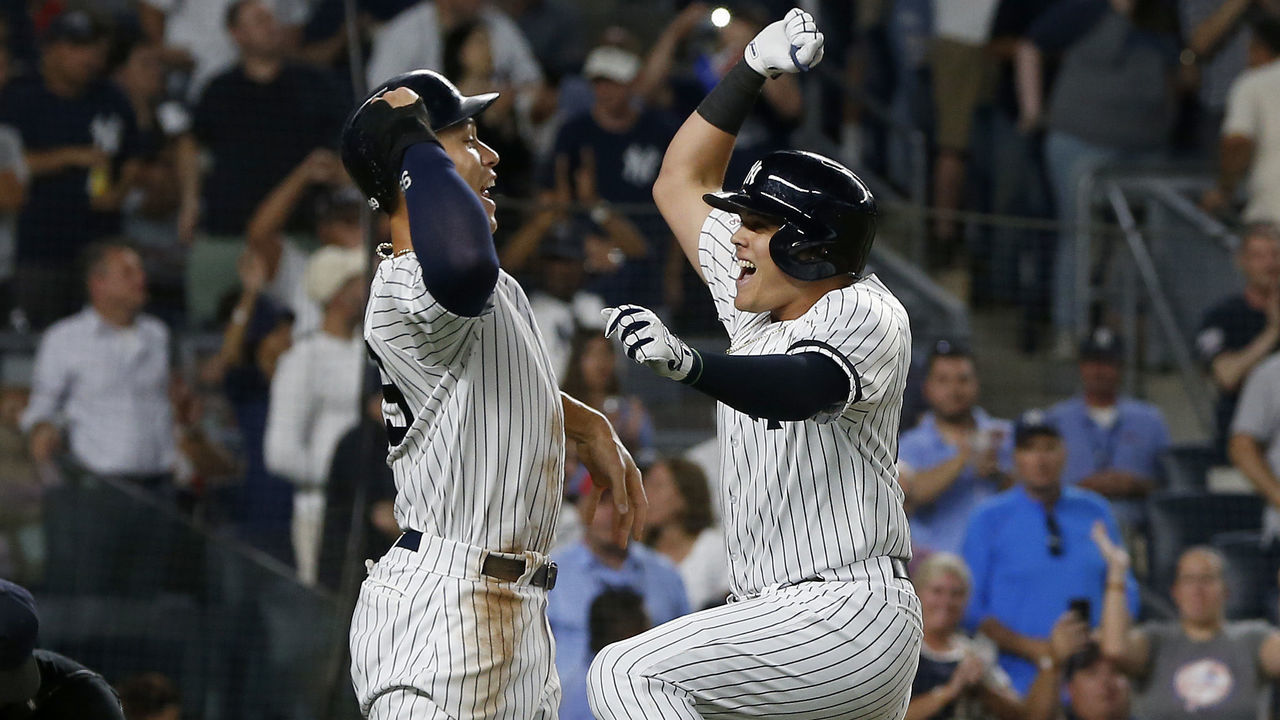 NEW YORK, NEW YORK - AUGUST 04: Gio Urshela #29 (R) of the New York Yankees celebrates his two-run home run with teammate Aaron Judge #99 against the Boston Red Sox in the third inning at Yankee Stadium on August 04, 2019 in New York City.