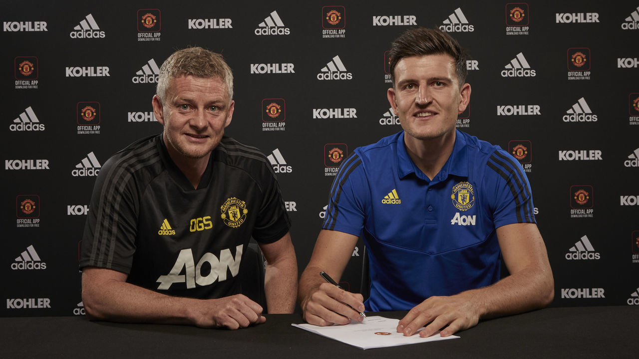 MANCHESTER, ENGLAND - AUGUST 04: (EXCLUSIVE COVERAGE) Harry Maguire of Manchester United poses with Manager Ole Gunnar Solskjaer after signing for the club at Aon Training Complex on August 04, 2019 in Manchester, England.