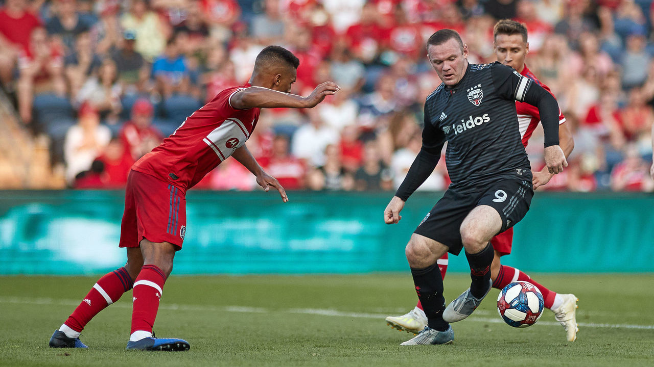 BRIDGEVIEW, IL - JULY 27: D.C. United forward Wayne Rooney (9) battles with Chicago Fire midfielder Przemyslaw Frankowski (11) and Chicago Fire defender Johan Kappelhof (4) in game action during a MLS match between D.C. United and Chicago Fire on July 27, 2019 at SeatGeek Stadium in Bridgeview, IL.
