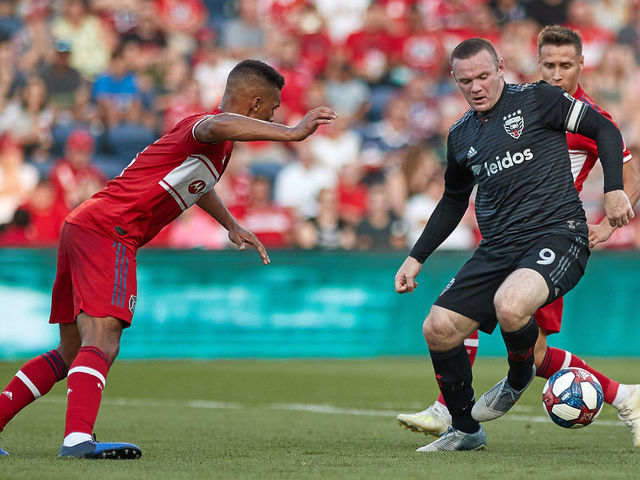 BRIDGEVIEW, IL - JULY 27: D.C. United forward Wayne Rooney (9) battles with Chicago Fire midfielder Przemyslaw Frankowski (11) and Chicago Fire defender Johan Kappelhof (4) in game action during a MLS match between D.C. United and Chicago Fire on July 27, 2019 at SeatGeek Stadium in Bridgeview, IL.