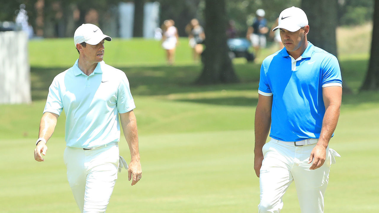 MEMPHIS, TENNESSEE - JULY 28: Brooks Koepka and Rory McIlroy of Northern Ireland walk to the green on the fourth hole during the final round of the World Golf Championship-FedEx St Jude Invitational at TPC Southwind on July 28, 2019 in Memphis, Tennessee.