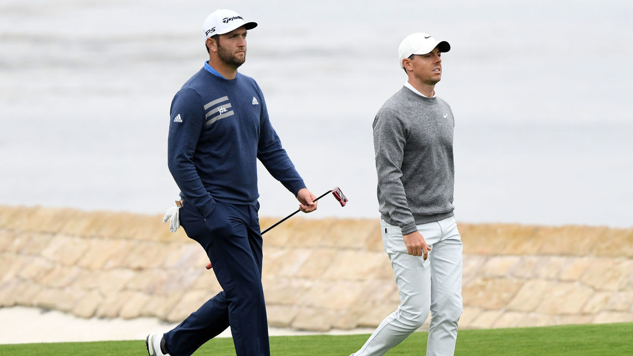 PEBBLE BEACH, CALIFORNIA - JUNE 14: Jon Rahm of Spain (L) and Rory McIlroy of Northern Ireland walk up the 18th hole during the second round of the 2019 U.S. Open at Pebble Beach Golf Links on June 14, 2019 in Pebble Beach, California.