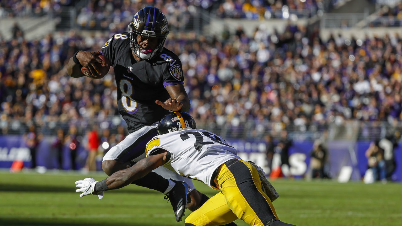 BALTIMORE, MD - NOVEMBER 04: Lamar Jackson #8 of the Baltimore Ravens attempts to stiff-arm Mike Hilton #28 of the Pittsburgh Steelers during the second quarter at M&T Bank Stadium on November 4, 2018 in Baltimore, Maryland.