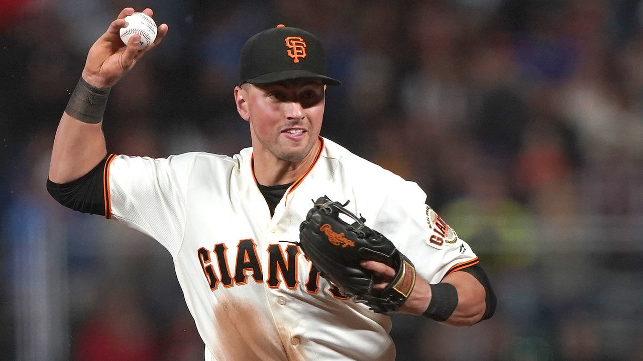 SAN FRANCISCO, CA - JULY 22: Joe Panik #12 of the San Francisco Giants throws off balance to first base thowing out Robel Garcia #16 of the Chicago Cubs in the top of the eighth inning at Oracle Park on July 22, 2019 in San Francisco, California.