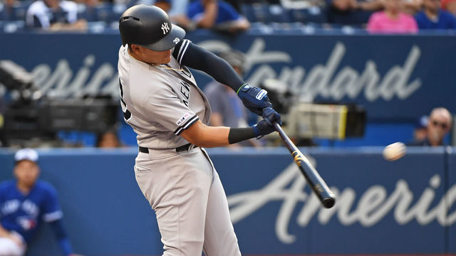 TORONTO, ON - AUGUST 08: New York Yankees Infield Gio Urshela (29) hits a first inning two run home run during the regular season MLB game between the New York Yankees and Toronto Blue Jays on August 8, 2019 at Rogers Centre in Toronto, ON.