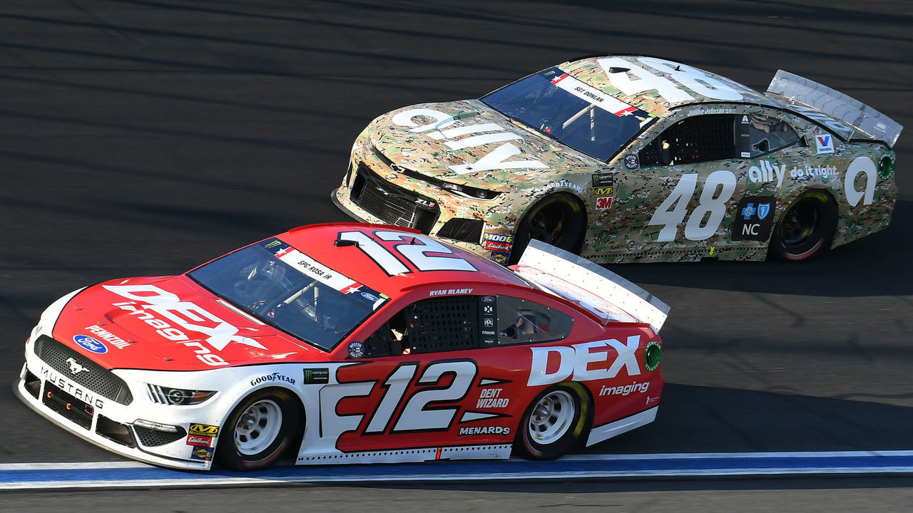 CHARLOTTE, NC - MAY 26: Ryan Blaney, Team Penske, Ford Mustang Dex Imaging (12) and Jimmie Johnson, Hendrick Motorsports, Chevrolet Camaro Ally Patriotic (48) race side by side during the 60th Annual Monster Energy Cup Series Coca-Cola 600 on May 26, 2019, at Charlotte Motor Speedway in Concord, NC.