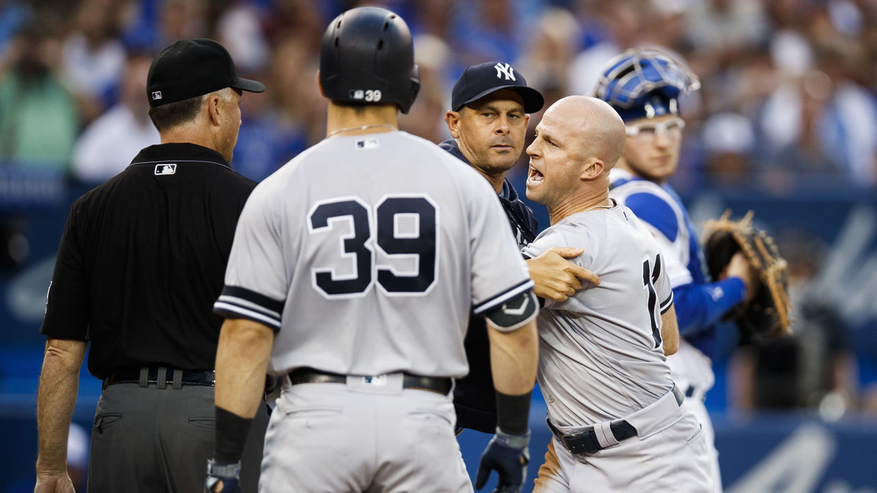 TORONTO, ONTARIO - AUGUST 9: Brett Gardner #11 of the New York Yankees is held back by manager Aaron Boone as he argues with umpires while playing the Toronto Blue Jays in the fourth inning during their MLB game at the Rogers Centre on August 9, 2019 in Toronto, Canada.