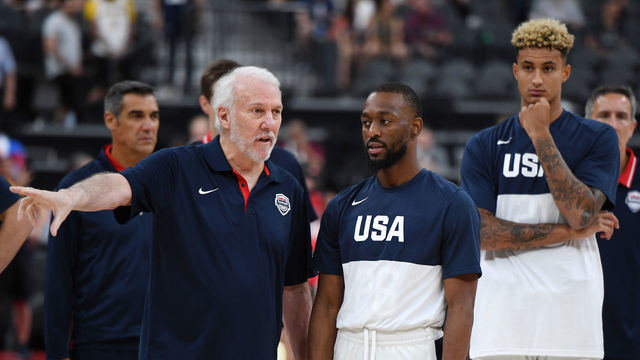 LAS VEGAS, NEVADA - AUGUST 09: (L-R) Head coach Gregg Popovich of the 2019 USA Men's National Team talks with Kemba Walker #26 of the 2019 USA Men's National Team as Kyle Kuzma #21 of the 2019 USA Men's National Team looks on before the 2019 USA Basketball Men's National Team Blue-White exhibition game at T-Mobile Arena on August 9, 2019 in Las Vegas, Nevada.
