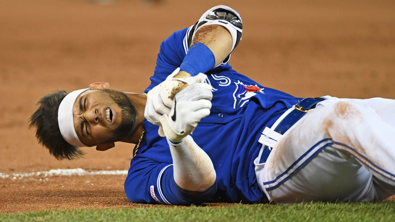 TORONTO, ON - AUGUST 08: Toronto Blue Jays Outfield Lourdes Gurriel Jr. (13) grimaces in pain after landing awkwardly at first base during the regular season MLB game between the New York Yankees and Toronto Blue Jays on August 8, 2019 at Rogers Centre in Toronto, ON.