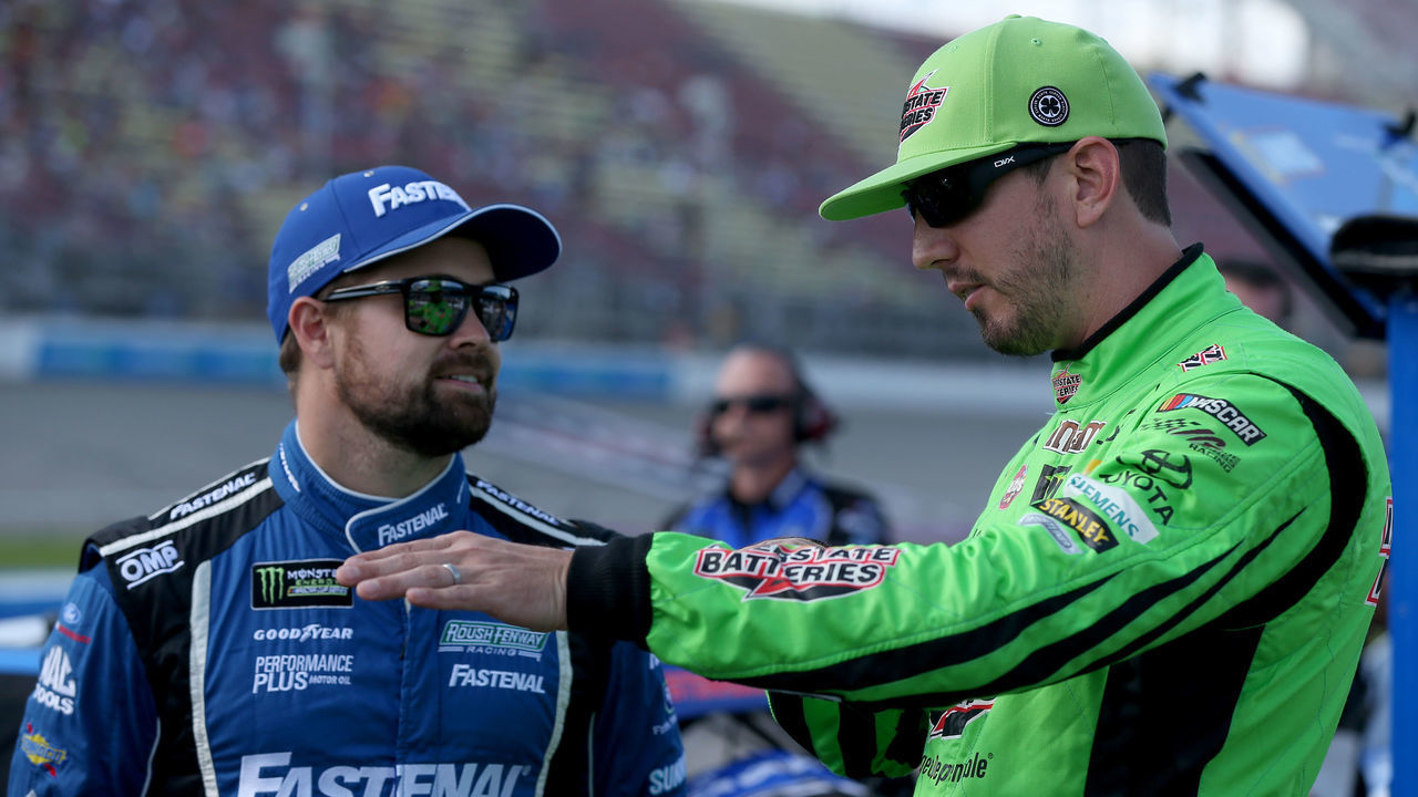 BROOKLYN, MICHIGAN - AUGUST 09: Ricky Stenhouse Jr, driver of the #17 Fastenal Ford, talks with Kyle Busch, driver of the #18 Interstate Batteries Toyota, during qualifying for the Monster Energy NASCAR Cup Series Consumers Energy 400 at Michigan International Speedway on August 09, 2019 in Brooklyn, Michigan.