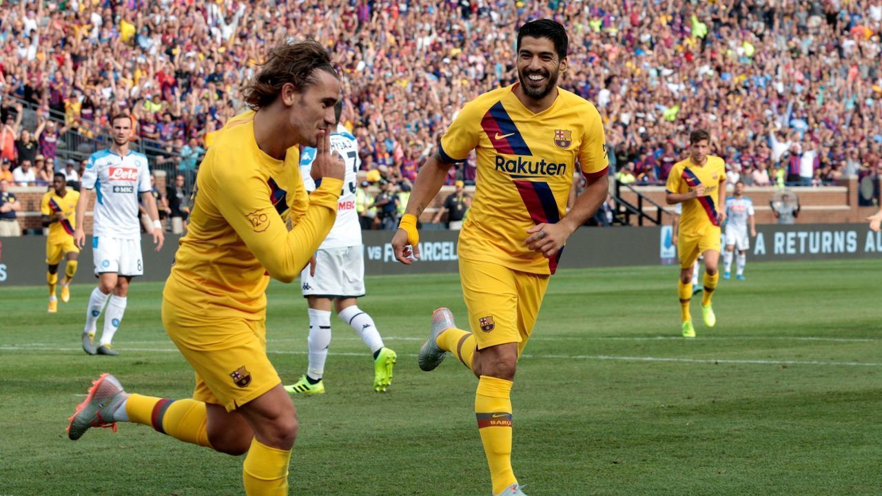 FC Barcelona's Luis Suarez (R) celebrates his goal with teammate Antoine Griezmann during the second half of the La Liga-Serie A Cup match between FC Barcelona and SSC Napoli on August 10, 2019 at Michigan Stadium in Ann Arbor, Michigan.