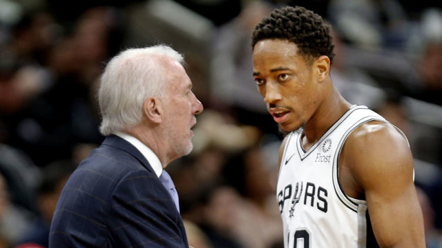 SAN ANTONIO,TX - DECEMBER 11: DeMar DeRozan #10 of the San Antonio Spurs listens to head coach Gregg Popovich during game against the Phoenix Suns at AT&T Center on December 11, 2018 in San Antonio, Texas. NOTE TO USER: User expressly acknowledges and agrees that , by downloading and or using this photograph, User is consenting to the terms and conditions of the Getty Images License Agreement.