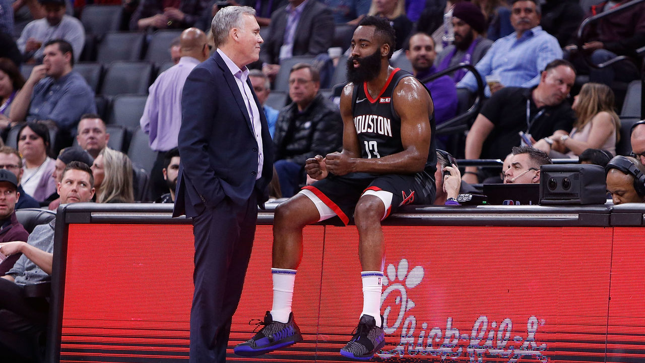 SACRAMENTO, CA - APRIL 02: James Harden #13 of the Houston Rockets sits on the scorers table talking to head coach Mike D'Antoni during a timeout from the game against the Sacramento Kings at Golden 1 Center on April 2, 2019 in Sacramento, California.