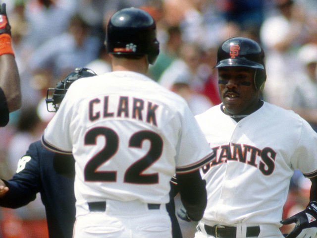 SAN FRANCISCO, CA - CIRCA 1989: Kevin Mitchell #7 of the San Francisco Giants is congratulated by Will Clark #22 after Mitchell hit a home run during a Major League Baseball game circa 1989 at Candlestick Park in San Francisco, California. Mitchell played for the Giants in 1987-91.