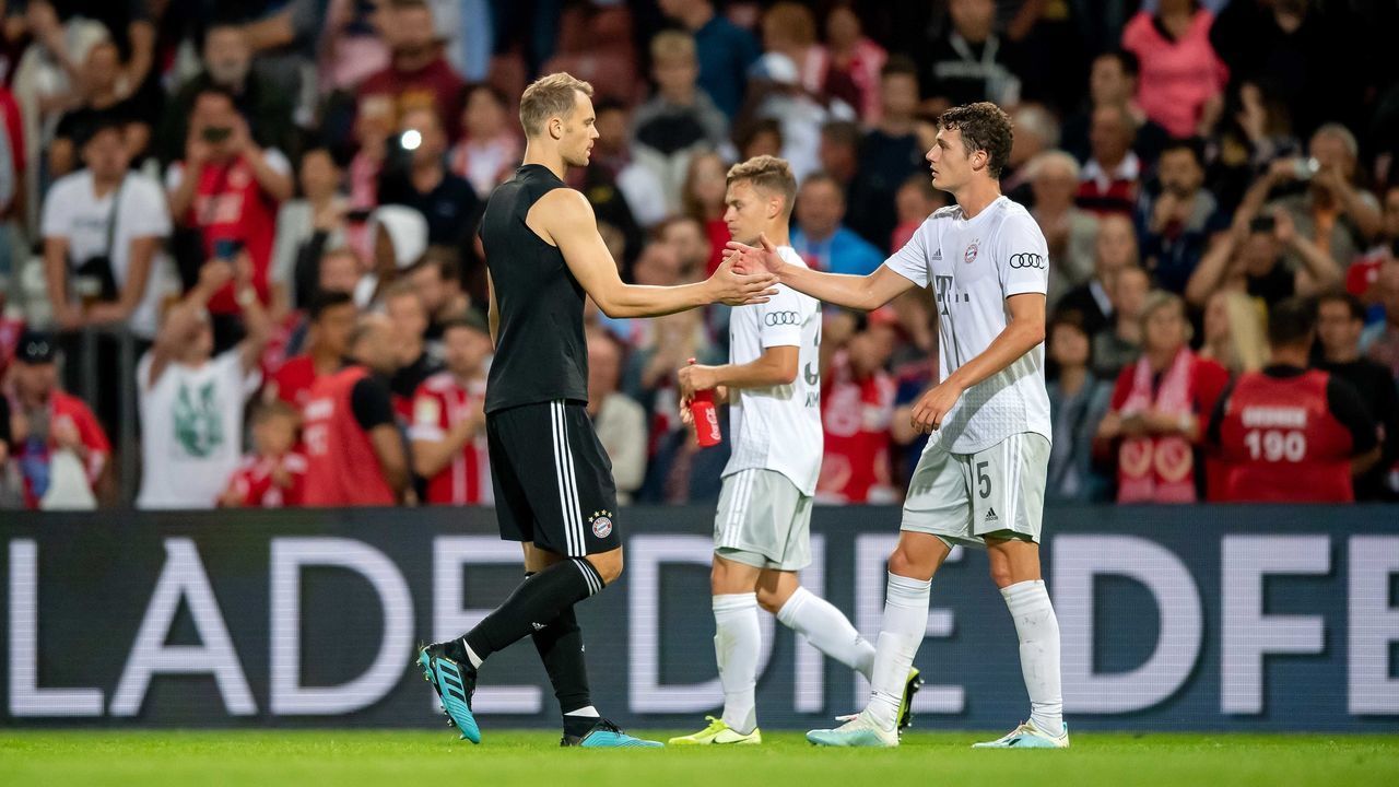 COTTBUS, GERMANY - AUGUST 12: Manuel Neuer (L) of Muenchen celebrates with Benjamin Pavard after the DFB Cup first round match between Energie Cottbus and FC Bayern Muenchen at Stadion der Freundschaft on August 12, 2019 in Cottbus, Germany.
