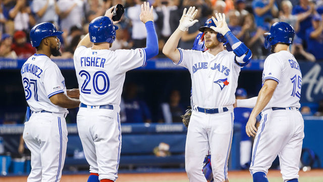 TORONTO, ONTARIO - AUGUST 12: Brandon Drury #3 of the Toronto Blue Jays celebrates his grand slam with teammates Teoscar Hernandez #37, Derek Fisher #20, and Randal Grichuk #15 in the fourth inning during their MLB game against the Texas Rangers at Rogers Centre on August 12, 2019 in Toronto, Canada.