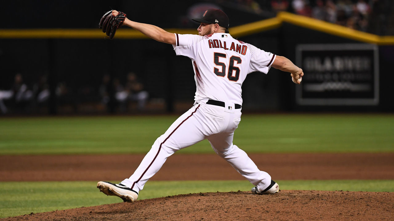 PHOENIX, ARIZONA - JULY 24: Greg Holland #56 of the Arizona Diamondbacks delivers a ninth inning pitch against the Baltimore Orioles at Chase Field on July 24, 2019 in Phoenix, Arizona. Diamondbacks won 5-2 and it was Lopez's first MLB save.