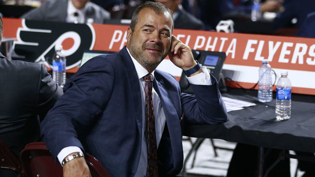 VANCOUVER, BRITISH COLUMBIA - JUNE 21: Head coach Alain Vigneault fo the Philadelphia Flyers looks on from the team draft table during the first round of the 2019 NHL Draft at Rogers Arena on June 21, 2019 in Vancouver, Canada.