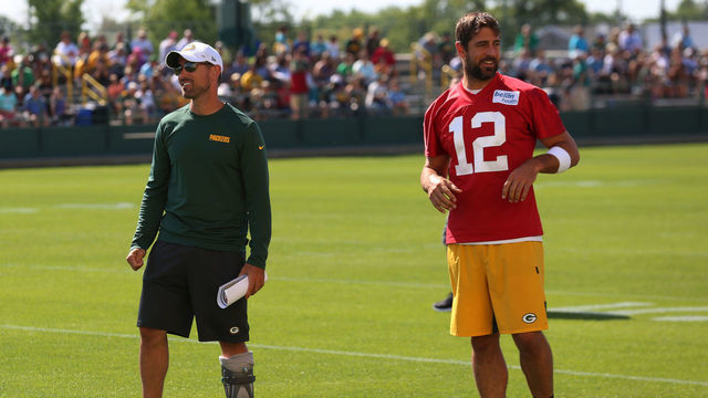 ASHWAUBENON, WI - AUGUST 01: Green Bay Packers quarterback Aaron Rodgers (12) and Green Bay Packers head coach Matt LaFleur spend time together during Green Bay Packers training camp at Ray Nitschke Field on August 01, 2019 in Ashwaubenon, WI.