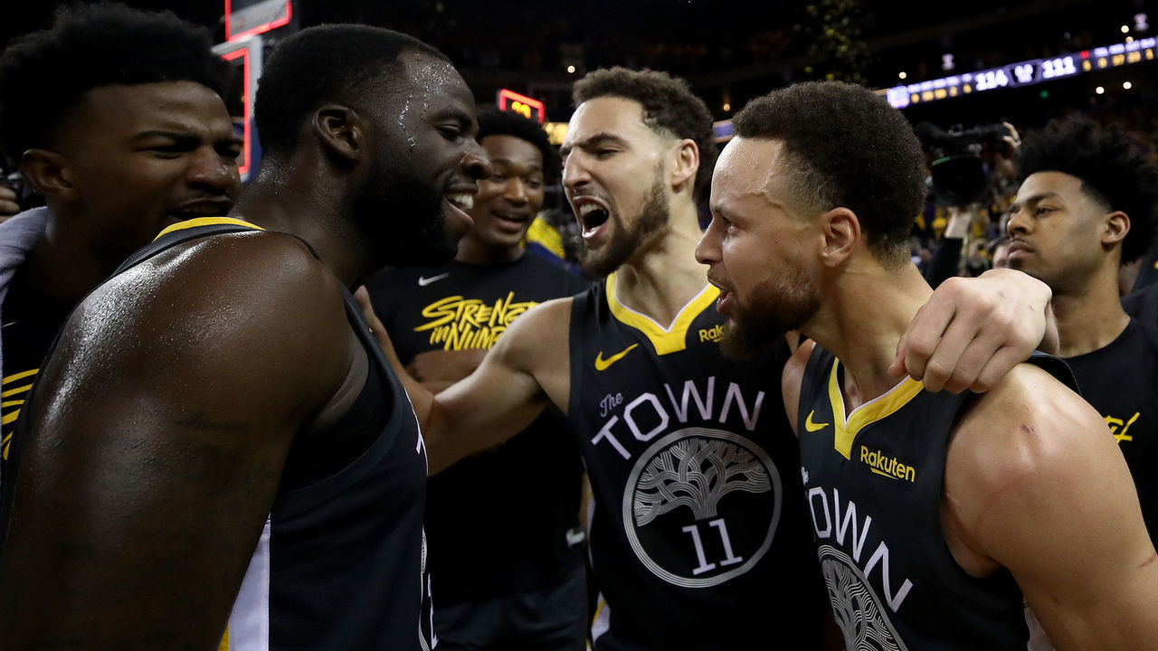 OAKLAND, CALIFORNIA - MAY 16: Stephen Curry #30, Klay Thompson #11 and Draymond Green #23 of the Golden State Warriors celebrate after defeating the Portland Trail Blazers 114-111 in game two of the NBA Western Conference Finals at ORACLE Arena on May 16, 2019 in Oakland, California.