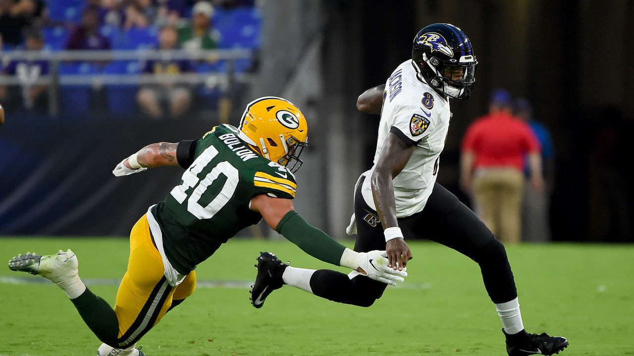 BALTIMORE, MD - AUGUST 15: Lamar Jackson #8 of the Baltimore Ravens runs in front of Curtis Bolton #40 of the Green Bay Packers during the first half of a preseason game at M&T Bank Stadium on August 15, 2019 in Baltimore, Maryland.
