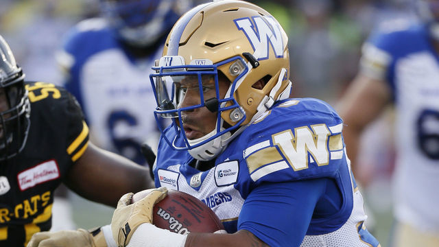 HAMILTON, ON - JULY 26: Andrew Harris #33 of the Winnipeg Blue Bombers rushes the football against the Hamilton Tiger-Cats at Tim Hortons Field on July 26, 2019 in Hamilton, Canada. Hamilton defeated Winnipeg 23-15.