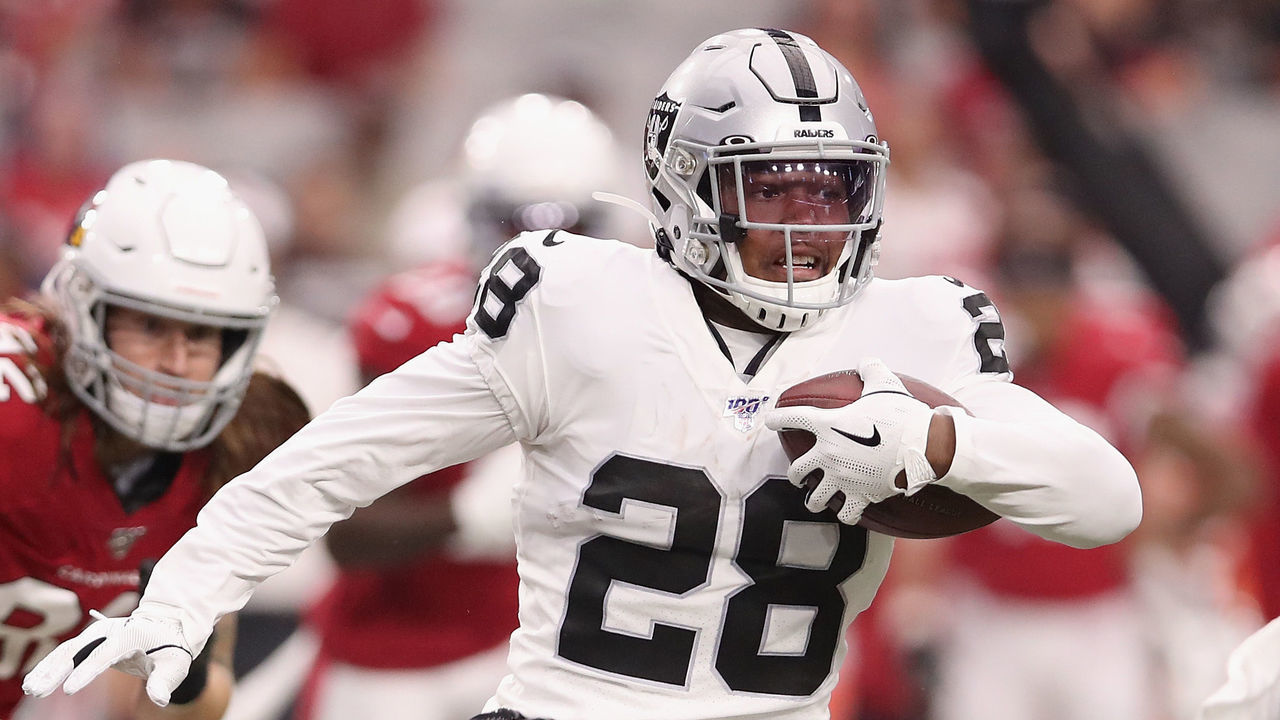 GLENDALE, ARIZONA - AUGUST 15: Running back Josh Jacobs #28 of the Oakland Raiders rushes the football past linebacker Chandler Jones #55 of the Arizona Cardinals during the first half of the NFL preseason game at State Farm Stadium on August 15, 2019 in Glendale, Arizona.