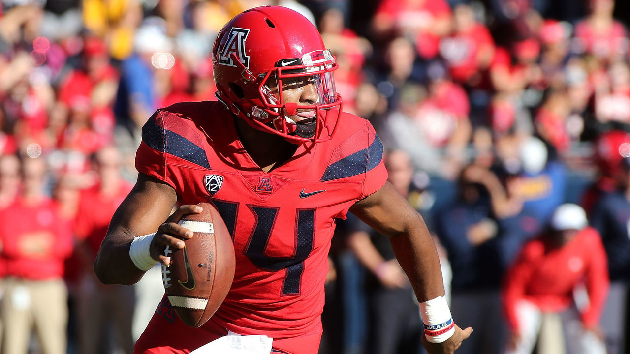 TUCSON, AZ - NOVEMBER 24: Quarterback Khalil Tate #14 of the Arizona Wildcats looks to throw a pass as he rolls out against the Arizona State Sun Devils during the first half of the college football game at Arizona Stadium on November 24, 2018 in Tucson, Arizona.