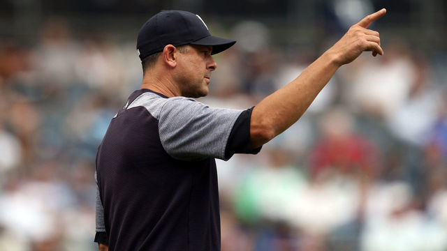BRONX, NY - AUGUST 14: Manager Aaron Boone #17 of the New York Yankees gestures to the bullpen during the game against the Baltimore Orioles at Yankee Stadium on Wednesday, August 14, 2019 in the Bronx borough of New York City.