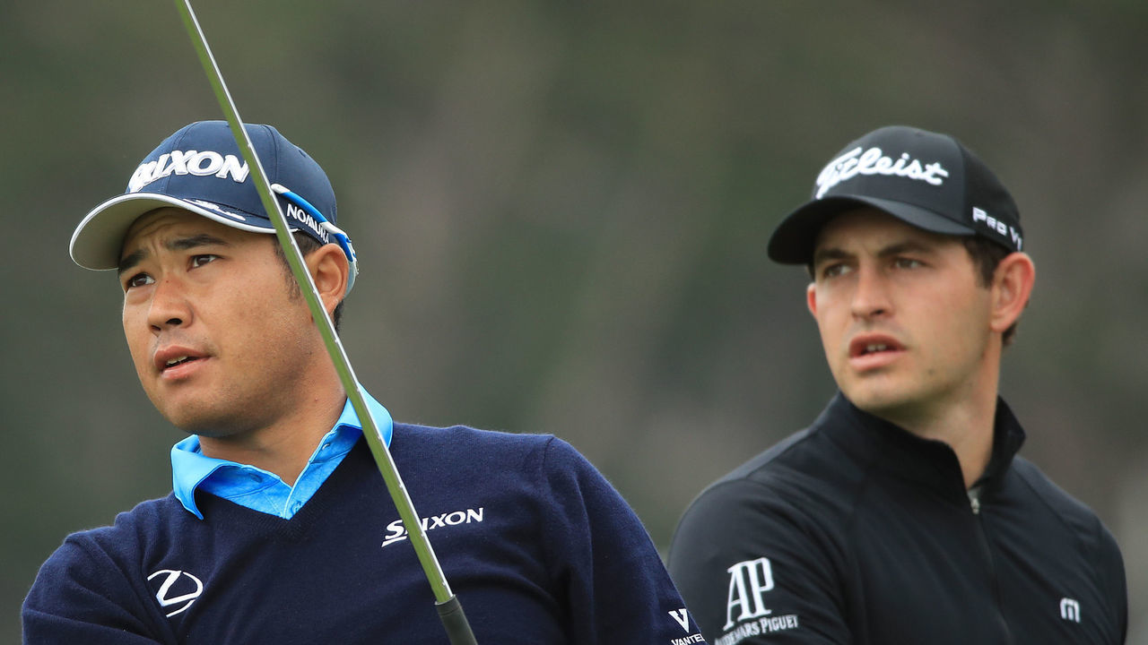 PEBBLE BEACH, CALIFORNIA - JUNE 16: Hideki Matsuyama of Japan (L) plays a shot from the fifth green as Patrick Cantlay of the United States looks on during the final round of the 2019 U.S. Open at Pebble Beach Golf Links on June 16, 2019 in Pebble Beach, California.