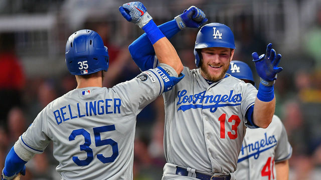 ATLANTA, GA AUGUST 16: Los Angeles Dodgers infielder Max Muncy (13) is congratulated by Cody Bellinger (35) after hitting a three run home run during the MLB game between the Los Angeles Dodgers and the Atlanta Braves on August 16th, 2019 at SunTrust Park in Atlanta, GA.