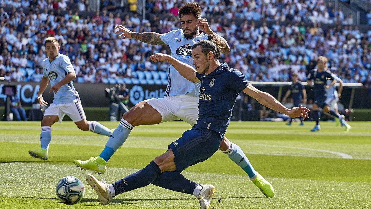 VIGO, SPAIN - AUGUST 17: David Costas of Celta de Vigo competes for the ball with Gareth Bale of Real Madrid during the Liga match between RC Celta de Vigo and Real Madrid CF at Abanca-Balaídos on August 17, 2019 in Vigo, Spain.