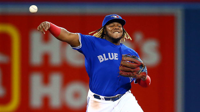TORONTO, ON - AUGUST 17: Vladimir Guerrero Jr. #27 of the Toronto Blue Jays throws to first base as Austin Nola #23 the Seattle Mariners singles in the second inning during a MLB game at Rogers Centre on August 17, 2019 in Toronto, Canada.