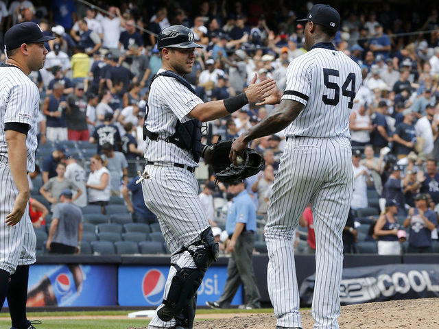 NEW YORK, NEW YORK - AUGUST 17: Gary Sanchez #24, Austin Romine #28 and Aroldis Chapman #54 of the New York Yankees celebrate after defeating the Cleveland Indians at Yankee Stadium on August 17, 2019 in New York City.