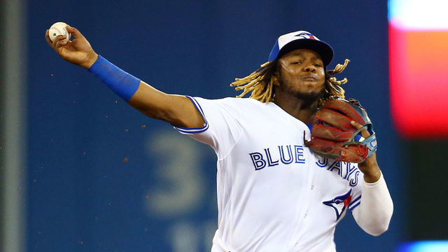 TORONTO, ON - AUGUST 16: Vladimir Guerrero Jr. #27 of the Toronto Blue Jays throws to first base as Omar Navarez #22 of the Seattle Mariners is out a second base in the sixth inning during a MLB game at Rogers Centre on August 16, 2019 in Toronto, Canada.